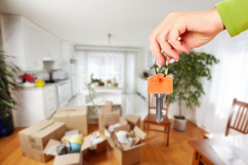 Trained movers handling boxes safely in a home removal job