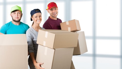 Packing and loading household furniture into a removals van