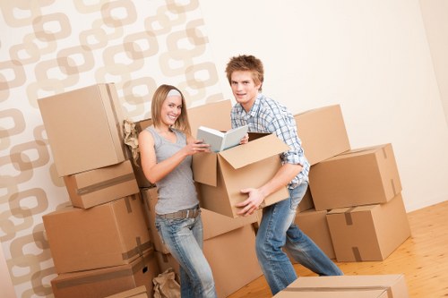 Professional movers carrying furniture from a house in Boundsgreen